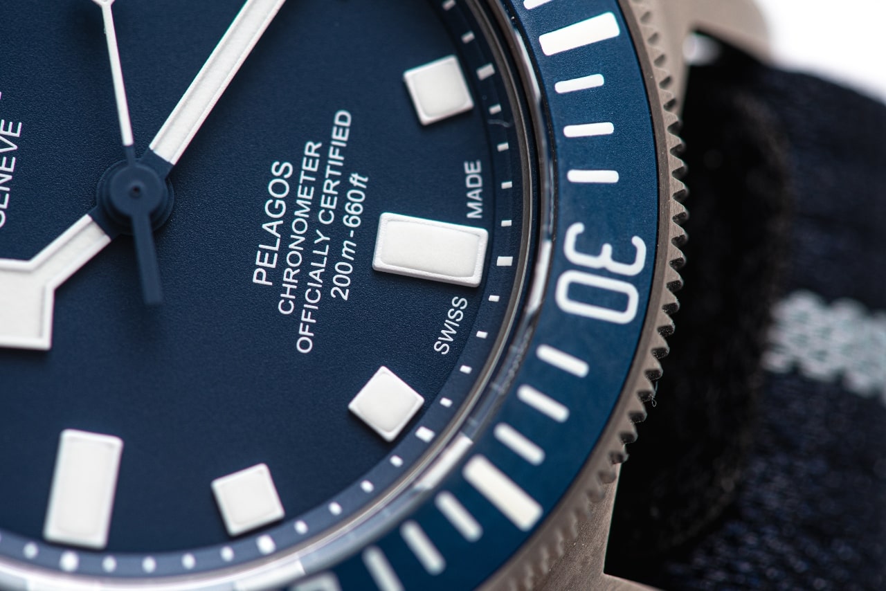 A close-up of a TUDOR Pelagos black watch dial.