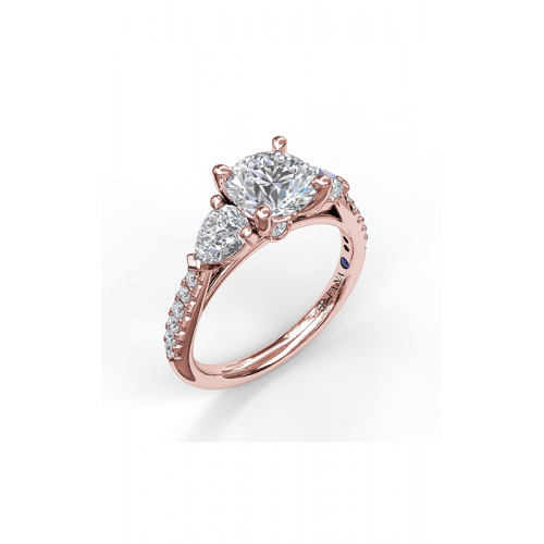 A three-stone rose gold ring: round center diamond framed by pear-shaped accents.
