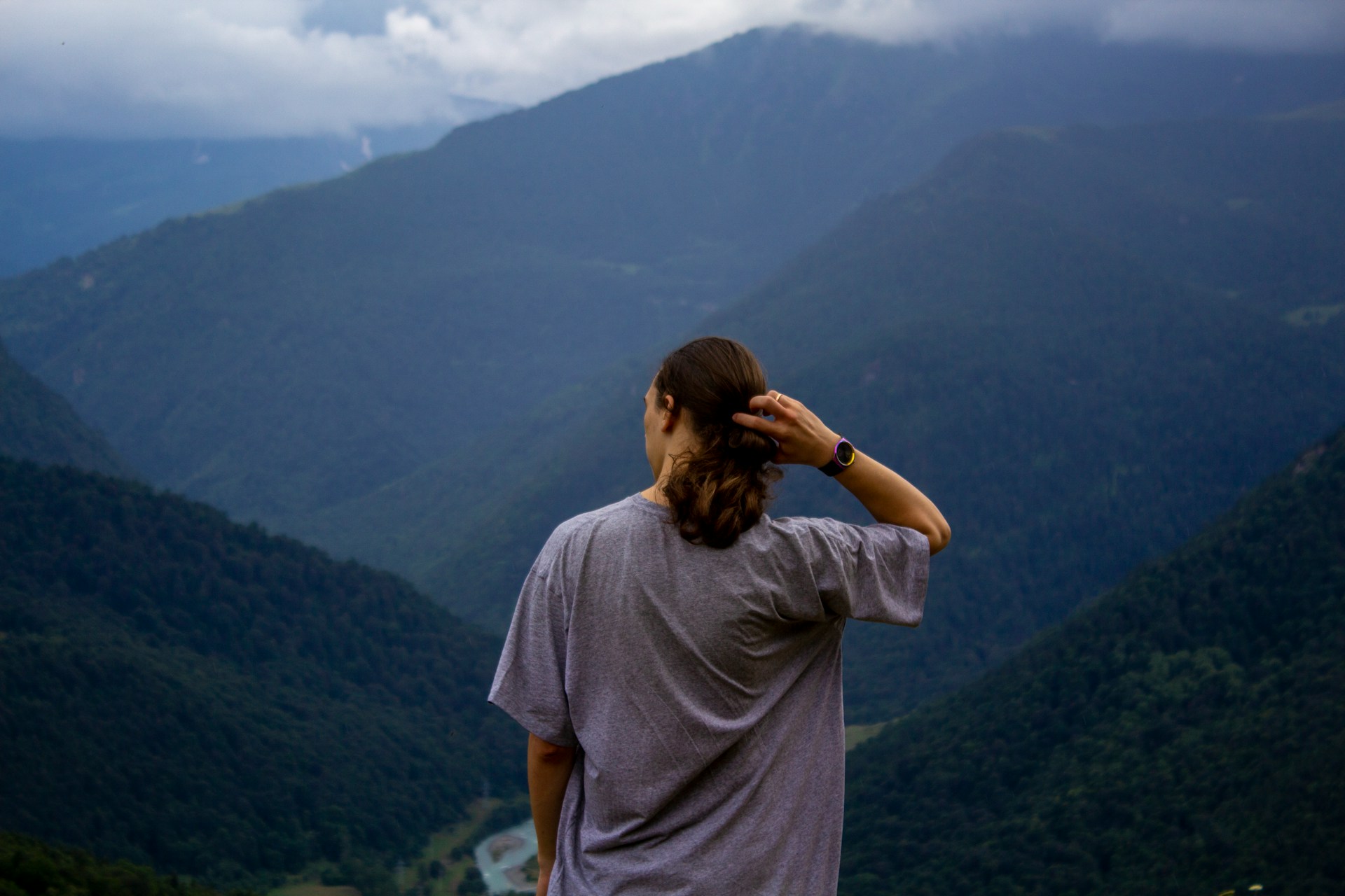 a man overlooking mountains wearing an outdoor watch