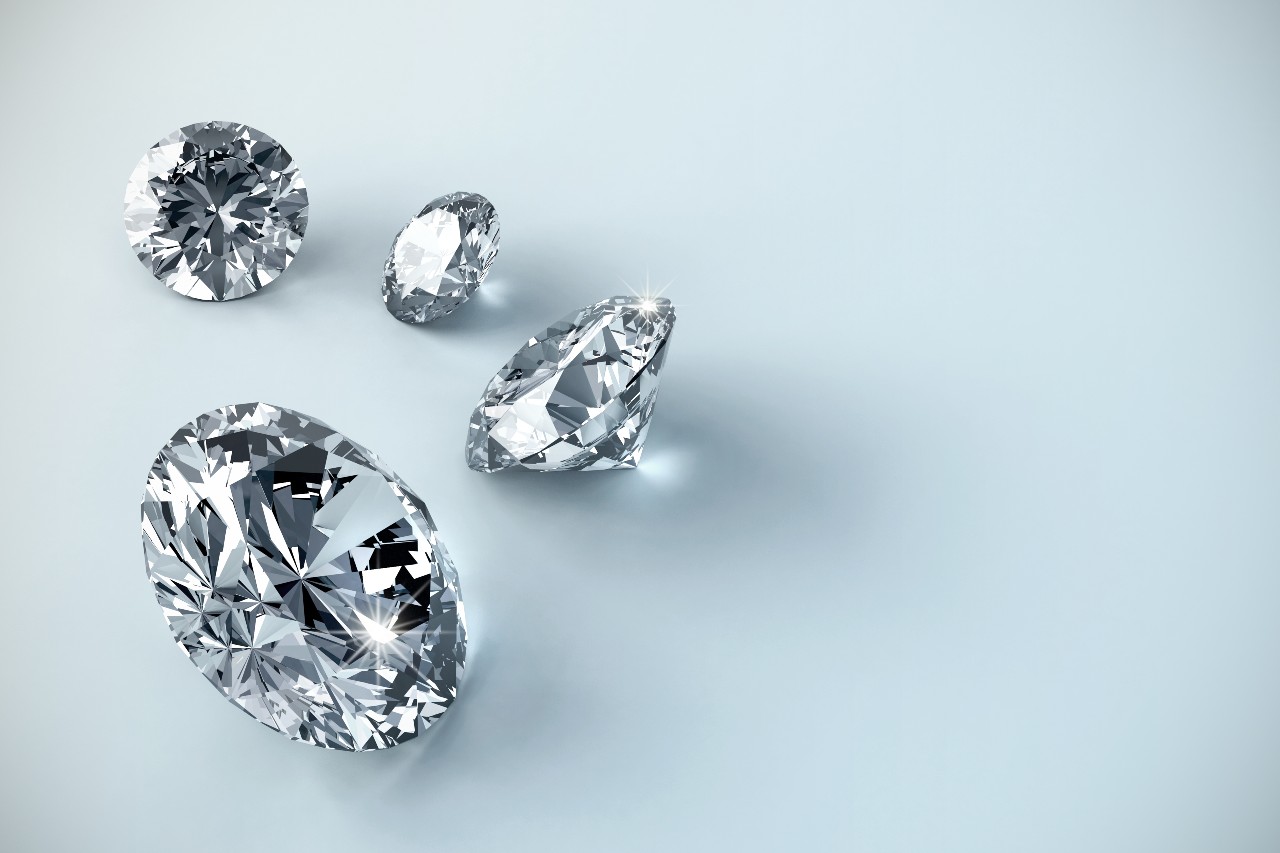 close up image of round cut diamonds on a light blue surface