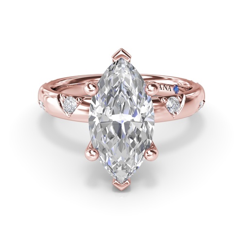 A rose gold diamond engagement ring with a marquise-cut diamond centerpiece.
