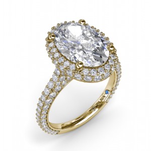 a yellow gold halo engagement ring with a large halo cut center stone