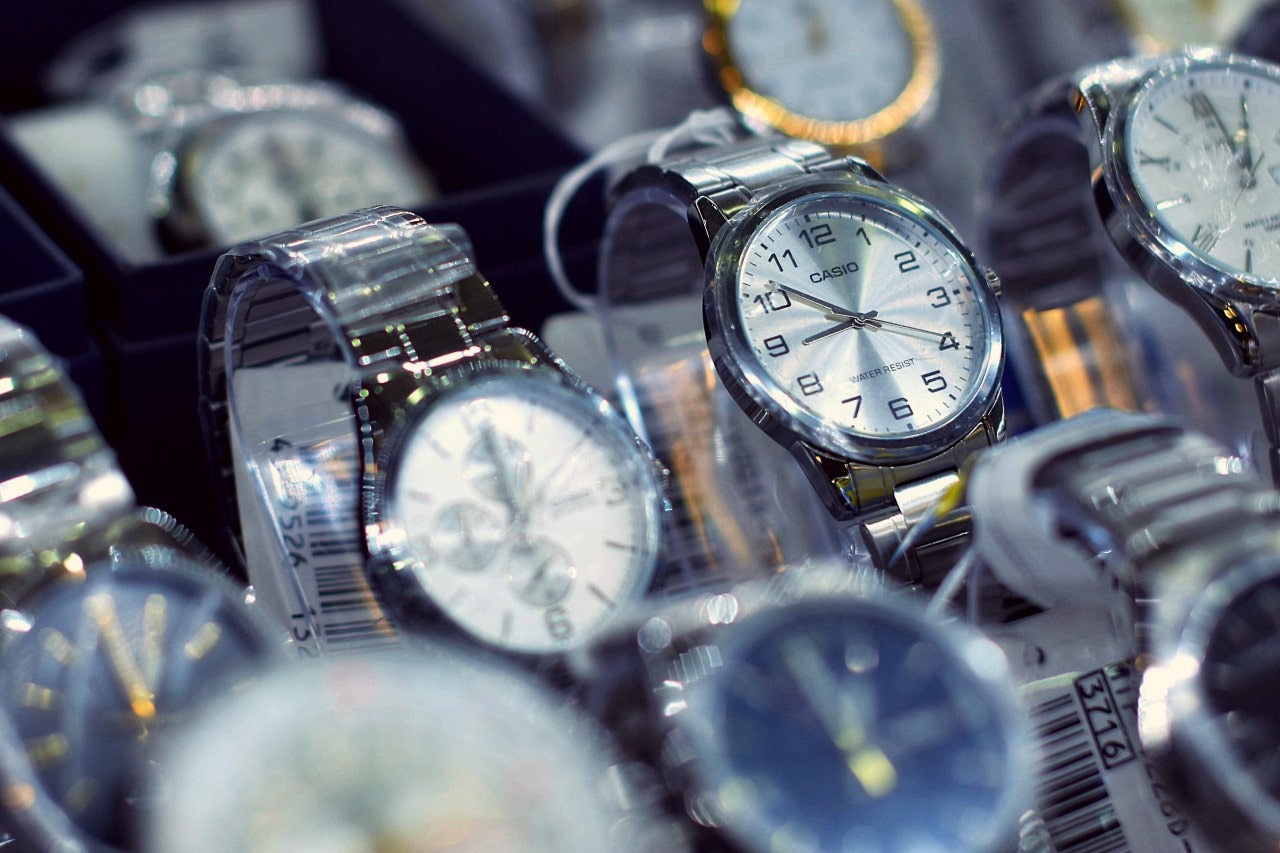 Close-up of several metallic Casio wristwatches displayed in a store.