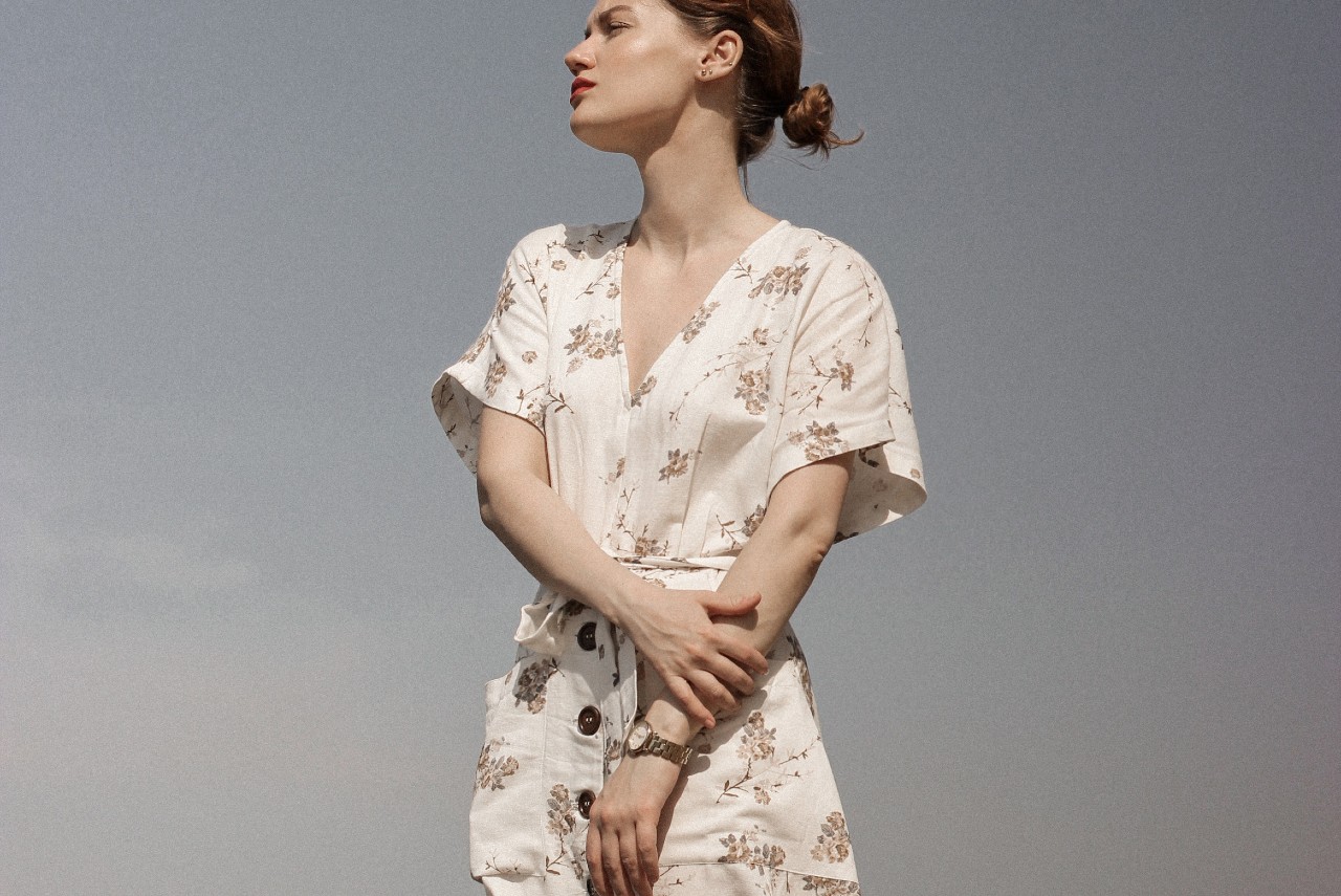 a lady wearing a luxury watch gazing off into the distance a lady wearing a luxury watch gazing off into the distance